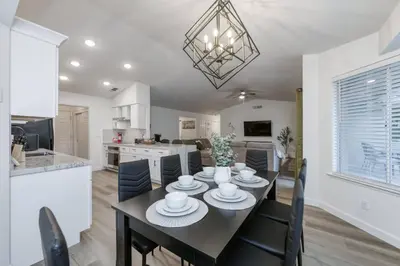 a dining room and kitchen with a table and chairs at Clovis Retreat Hottub & Firepit in Clovis