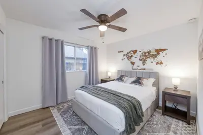 a bedroom with a bed and a ceiling fan at Clovis Retreat Hottub & Firepit in Clovis