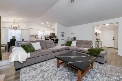 a living room with a couch and a table at Clovis Retreat Hottub & Firepit in Clovis