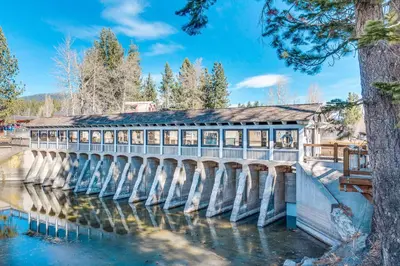 a bridge over a river with a building on it at Blue Lake Bliss in Tahoe City