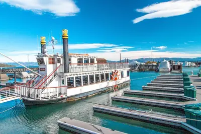 a ferry boat docked at a dock in the water at Tavern 16 in Olympic Valley