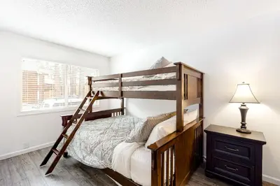 a bedroom with a bunk bed and a lamp at Sierra Townhome in Incline Village