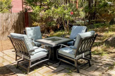 three chairs and a table in a yard with a table and three chairs at The Chalet at Kings Beach Unit 8 in Kings Beach