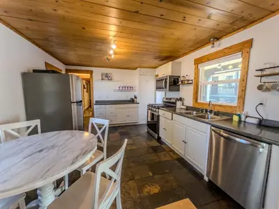 a kitchen with a wooden ceiling and a table at The Chalet at Kings Beach Unit 8 in Kings Beach
