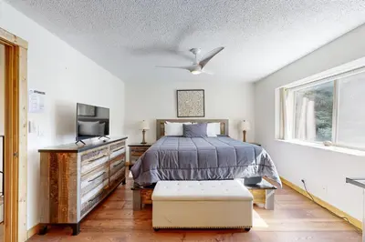 a bedroom with a bed and a tv and a window at Lake Forest Manor in Tahoe City