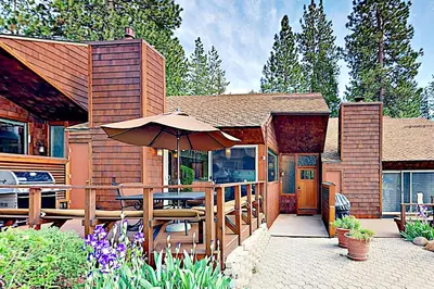 a patio with a table and an umbrella at Lake Tahoe Oasis in Kings Beach