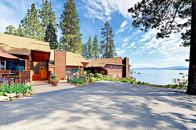 a house with a road next to a lake at Lake Tahoe Oasis in Kings Beach