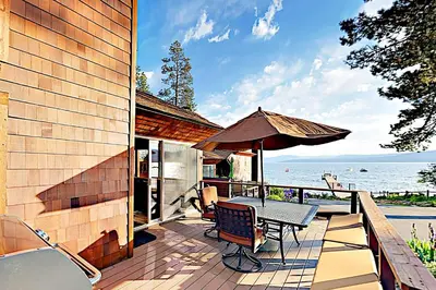 a patio with a table and an umbrella at Lake Tahoe Oasis in Kings Beach