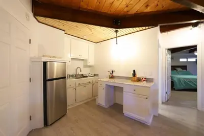 a kitchen with white cabinets and a stainless steel refrigerator at Spacious 3BR Retreat - Sleeps 10 - Free Parking in Camino