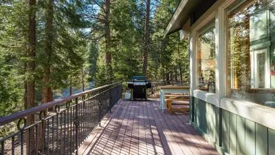 a porch of a house with a grill and trees at Year-Round Tahoe Escape with Hot Tub Outdoor Dining Timberline Haven by AvantStay in Tahoe Vista