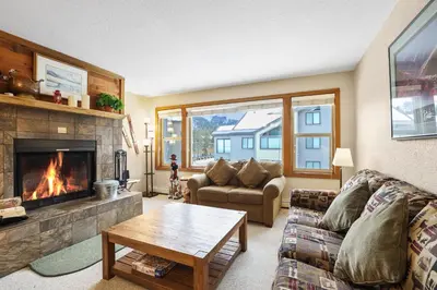 a living room with a couch and a fireplace at 2 Bedroom Kirkwood Condo – Across the Street from Village condo in Kirkwood