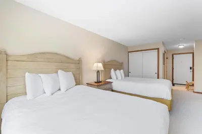 two beds in a hotel room with white pillows at 2 Bedroom Kirkwood Condo – Across the Street from Village condo in Kirkwood