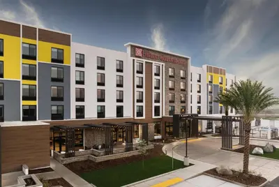 a rendering of a hotel building with a courtyard at Hilton Garden Inn Merced in Merced