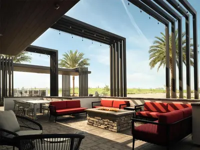 a patio with red chairs and a fire pit at Hilton Garden Inn Merced in Merced