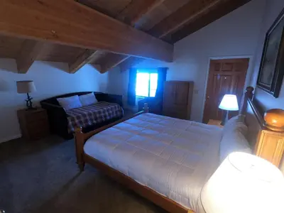 a bedroom with a large bed and a couch at Rr-interlaken 09 in June Lake