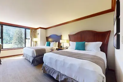 a hotel room with two beds and a large window at Everline Resort & Spa 630 in Olympic Valley