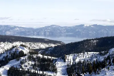a view of a snow covered mountain and a lake at Everline Resort & Spa 317 in Olympic Valley