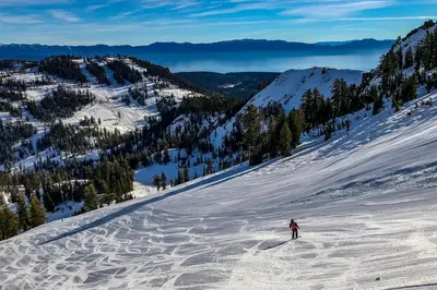 a person is skiing down a snow covered mountain at Everline Resort & Spa 317 in Olympic Valley