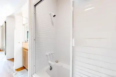 a white bathroom with a tub and a shower at Tahoe Safari in Incline Village