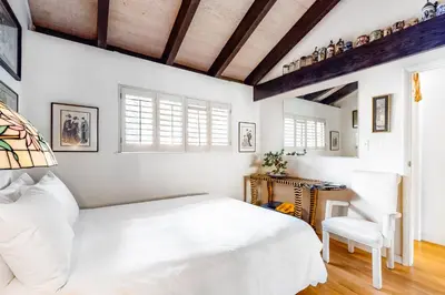 a bedroom with a white bed and a chair at Tahoe Safari in Incline Village
