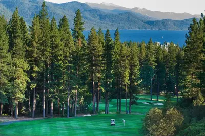 a view of a golf course with trees and water at Tahoe Safari in Incline Village