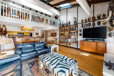 a living room with a blue leather couch and a television at Tahoe Safari in Incline Village