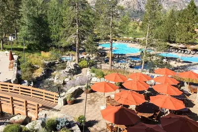 a resort with orange umbrellas and a swimming pool at Everline Resort & Spa 806 in Olympic Valley