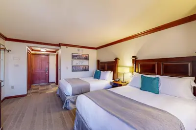 a hotel room with two beds and a hallway at Everline Resort & Spa 806 in Olympic Valley