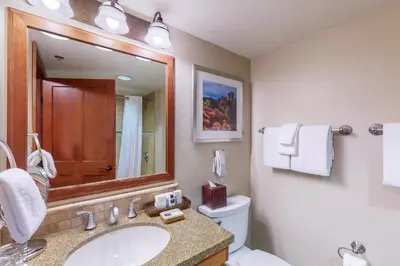 a bathroom with a sink and a toilet and a mirror at Everline Resort & Spa 806 in Olympic Valley
