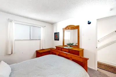 a bedroom with a bed and a mirror at Moose Roost in Incline Village