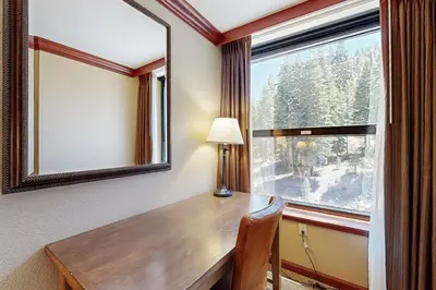 a desk in a room with a large window at Everline Resort & Spa 607B in Olympic Valley
