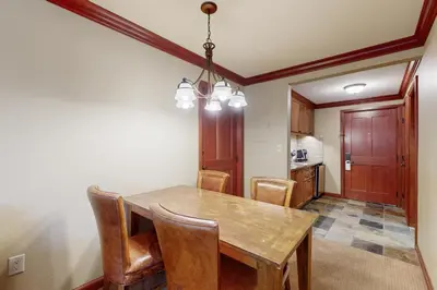 a dining room with a wooden table and chairs at Everline Resort & Spa 607B in Olympic Valley