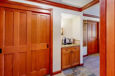 a room with wooden doors and a kitchen with a counter at Everline Resort & Spa 812 in Olympic Valley