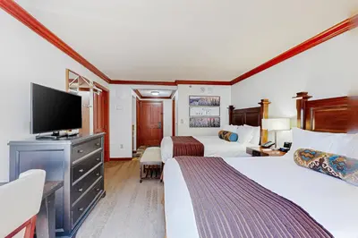 a hotel room with two beds and a flat screen tv at Everline Resort & Spa 523 in Olympic Valley