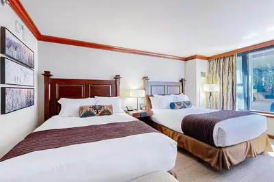 a hotel room with two beds and a window at Everline Resort & Spa 523 in Olympic Valley