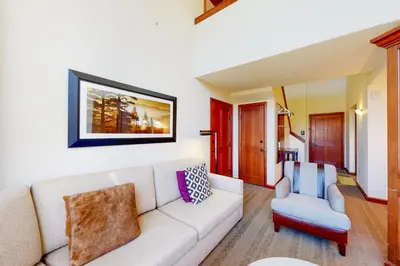 a living room with a couch and a chair at Everline Resort & Spa 810 in Olympic Valley