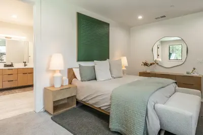 a bedroom with a bed and a mirror and a chair at The Reserve #126 in Mammoth Lakes
