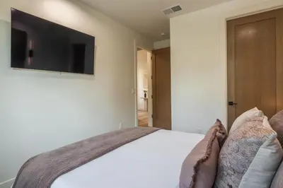 a bedroom with a bed with a flat screen tv on the wall at The Reserve #126 in Mammoth Lakes