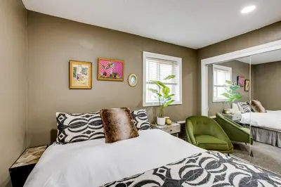 a bedroom with a bed and a green chair at Work and Play! Lake Tahoe Cabin 5 Mi to Heavenly Mtn in South Lake Tahoe