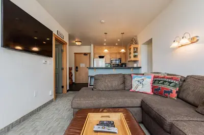 a living room with a couch and a table at Juniper Springs Lodge # 203 in Mammoth Lakes