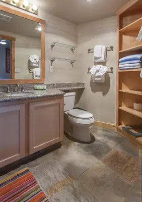 a bathroom with a toilet and a sink and a mirror at Juniper Springs Lodge # 426 in Mammoth Lakes