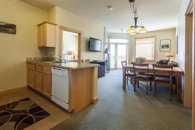 a kitchen and dining room with a table and chairs at Sunstone # 329 in Mammoth Lakes