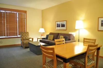 a living room with a table and a couch at Village # 2416 - White Mountain Lodge in Mammoth Lakes