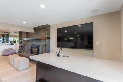 a kitchen with a sink and a fireplace in a living room at HCH0868 - The Grand Escape home in South Lake Tahoe