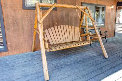 a swing on the porch of a house at 42A Megan in North Wawona