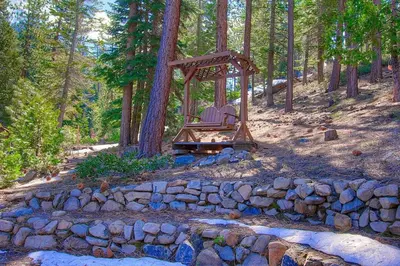 two chairs sitting in a swing in a forest at NVH0823 - Sadies Hustle home in Zephyr Cove