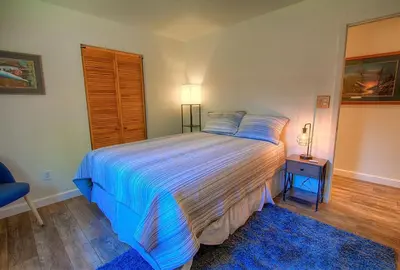 a bedroom with a large bed and a blue rug at NVH0823 - Sadies Hustle home in Zephyr Cove