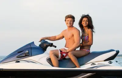 a man and a woman sitting on a jet ski at Leisure Landing Unwind in the Pines in Shaver Lake