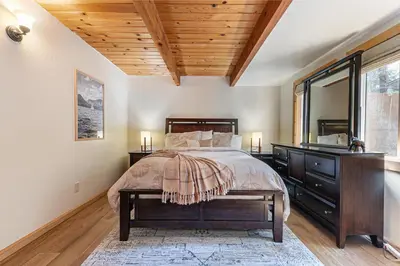 a bedroom with a bed and a wooden ceiling at Retreat with Private Hot Tub steps North Lake Tahoe in Carnelian Bay