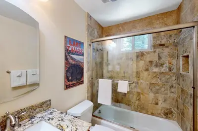a bathroom with a shower and a toilet and a sink at Brown Bear's Hideaway in Incline Village